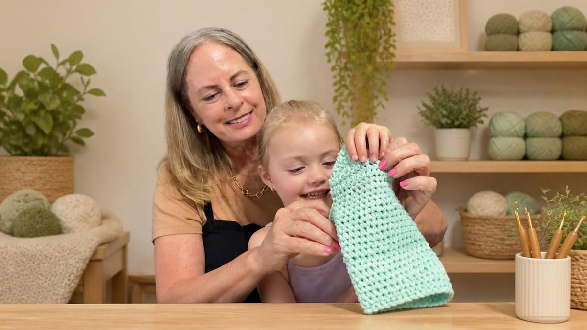 image of young girl admiring crochet project